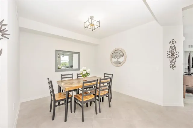 a living room with furniture and a kitchen view