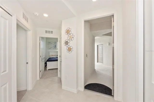 a front view of a house with glass windows and furniture