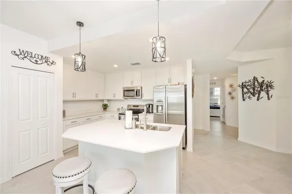 a kitchen with stainless steel appliances a refrigerator stove and microwave