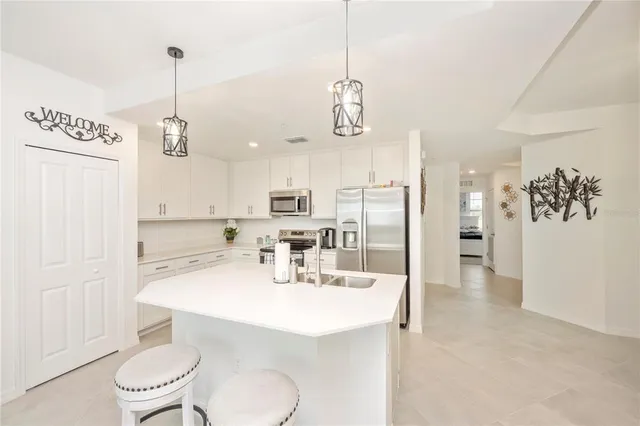 a kitchen with stainless steel appliances a refrigerator stove and microwave