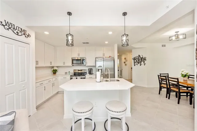 a kitchen that has a sink cabinets counter space and a view of kitchen