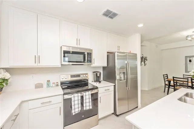 a view of a dining room with furniture and a chandelier