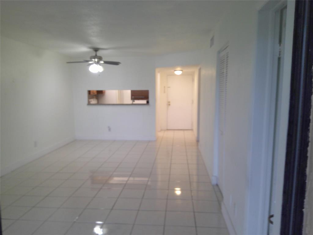 3199 Foxcroft Road, Unit 306 Miramar, FL 33025 - Photo 3 of 12 a view of empty room with a ceiling fan