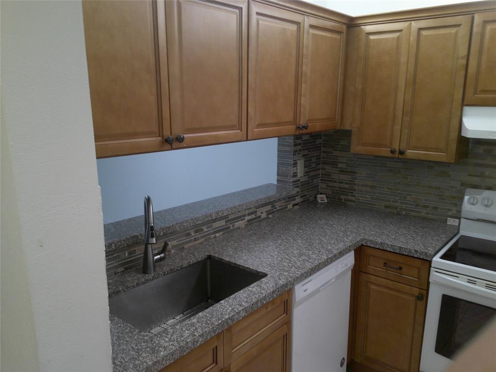 3199 Foxcroft Road, Unit 306 Miramar, FL 33025 - Photo 5 of 12 a kitchen with a sink and cabinets