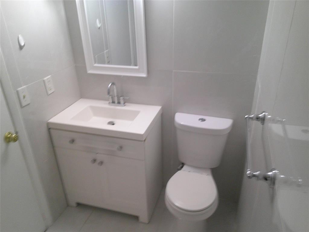 3199 Foxcroft Road, Unit 306 Miramar, FL 33025 - Photo 7 of 12 a bathroom with a toilet sink and mirror