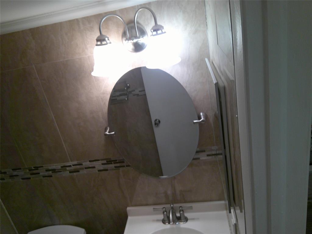 3199 Foxcroft Road, Unit 306 Miramar, FL 33025 - Photo 10 of 12 a bathroom with a sink and mirror