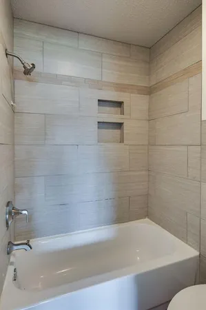 a bathroom with a bathtub and a shower