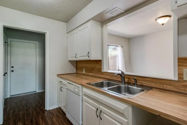 a kitchen that has a sink and cabinets