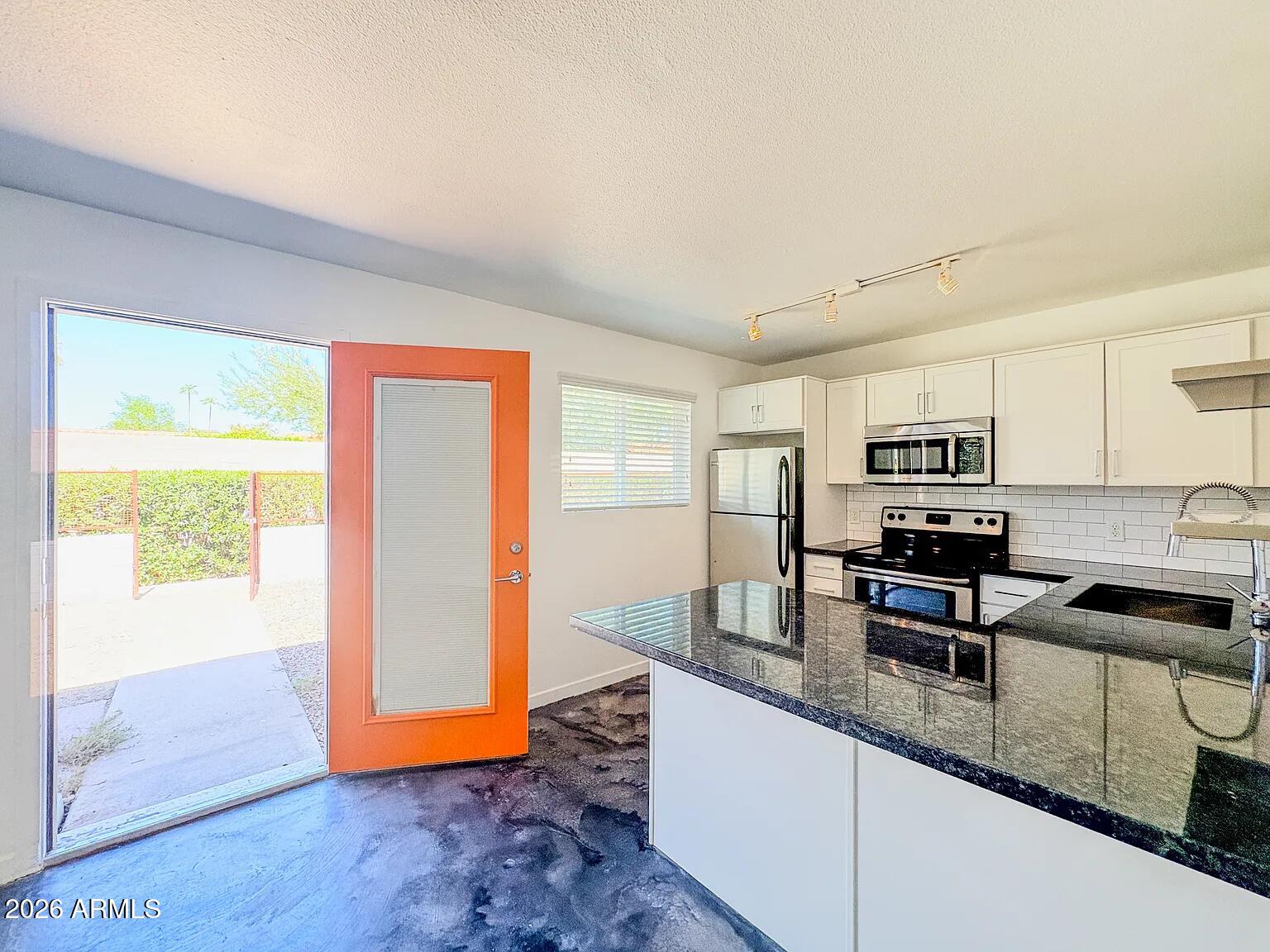 4231 North 27th Street, Unit 10 Phoenix, AZ 85016 - Photo 1 of 14 a kitchen with granite countertop a refrigerator and a sink