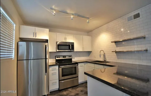 a kitchen with stainless steel appliances and a sink