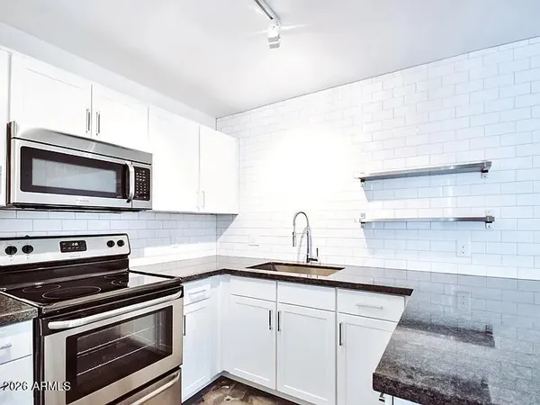 a kitchen with a sink stove and microwave