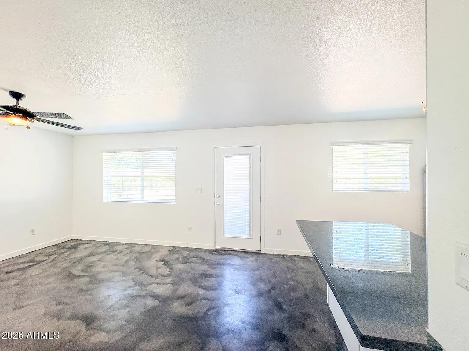 4231 North 27th Street, Unit 10 Phoenix, AZ 85016 - Photo 4 of 14 an empty room with windows
