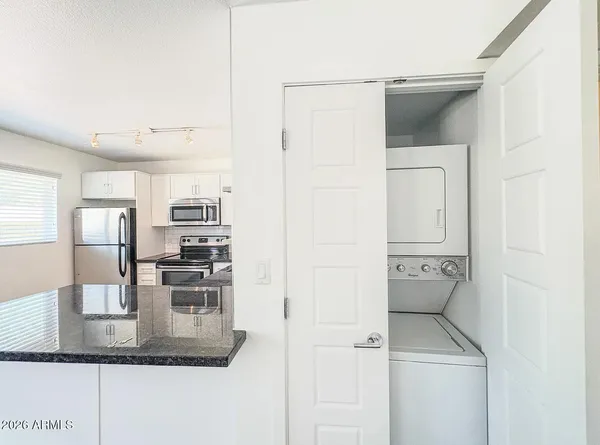 a kitchen with stainless steel appliances granite countertop a refrigerator and a sink