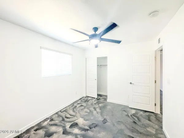 a view of a big room with closet and fan