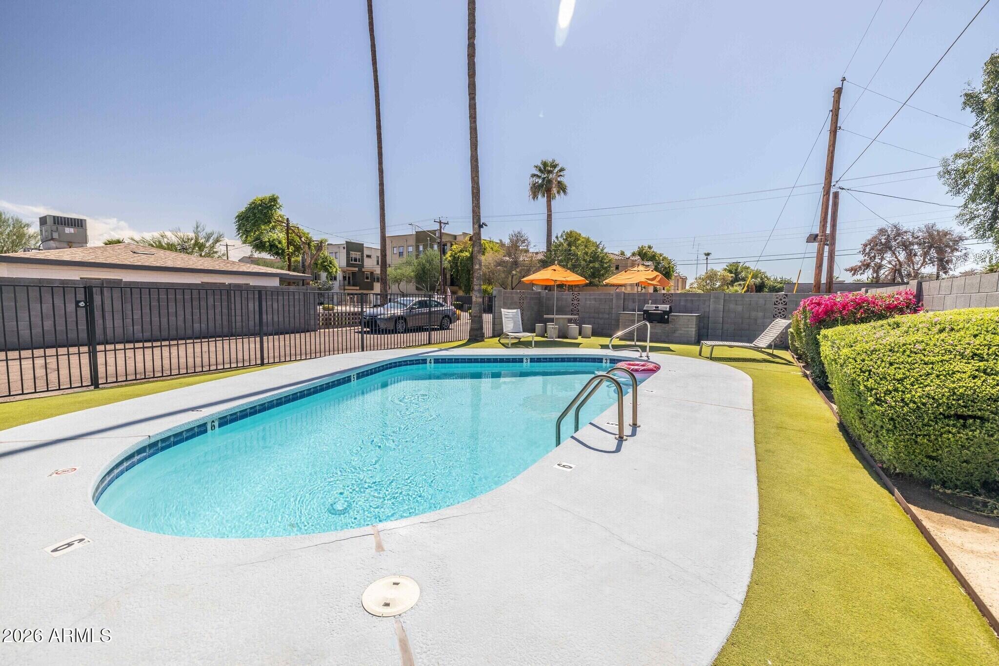 4231 North 27th Street, Unit 10 Phoenix, AZ 85016 - Photo 8 of 14 a view of swimming pool with outdoor seating
