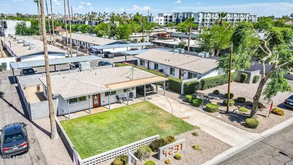 a view of a patio with couches table and chairs with potted plants