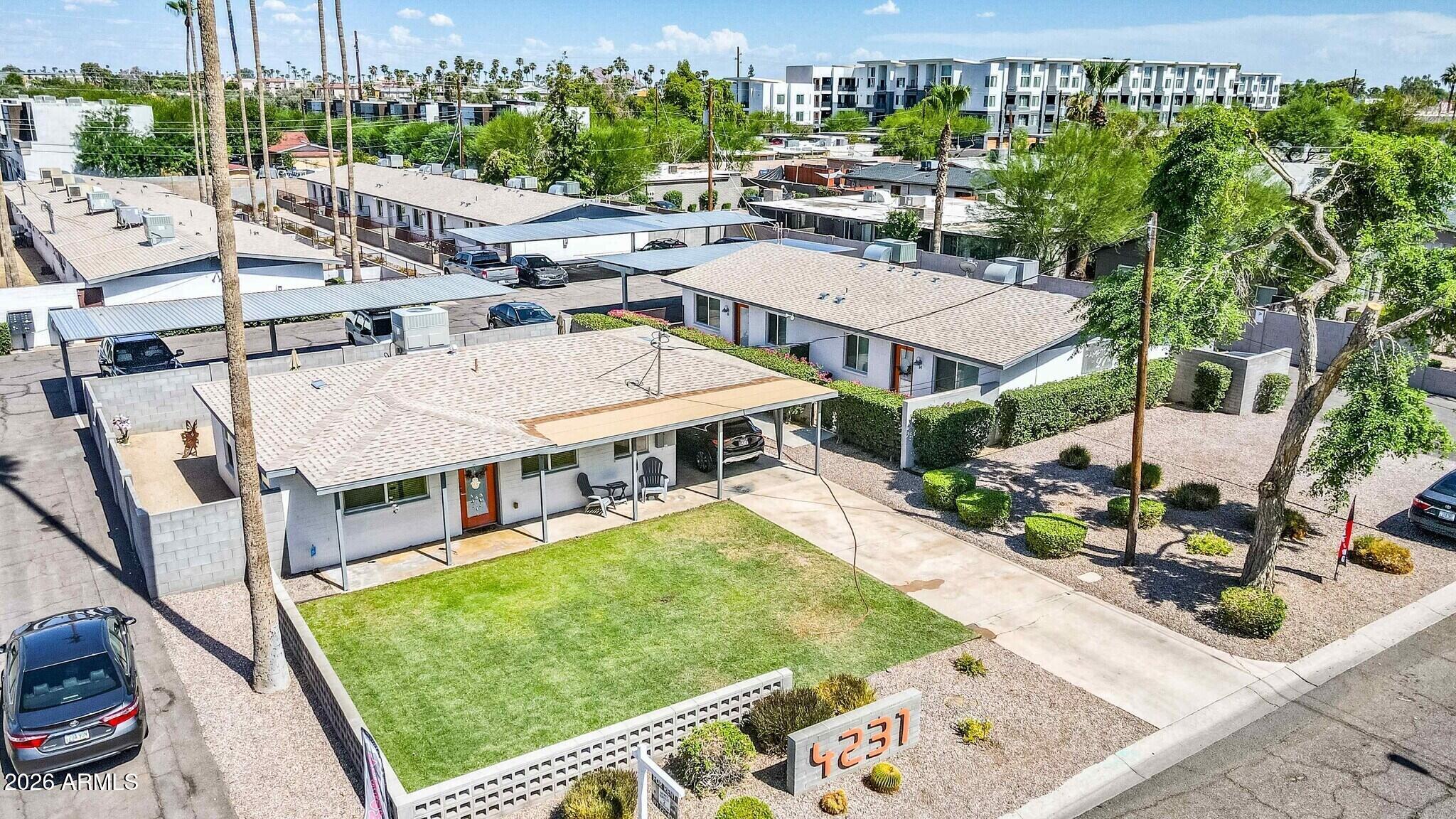 4231 North 27th Street, Unit 10 Phoenix, AZ 85016 - Photo 10 of 14 a view of a patio with couches table and chairs with potted plants