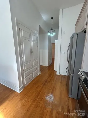 a view of a hallway with wooden floor and entryway