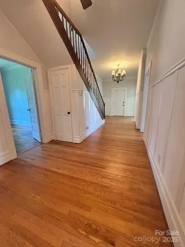 a view of a hallway with wooden floor and entryway
