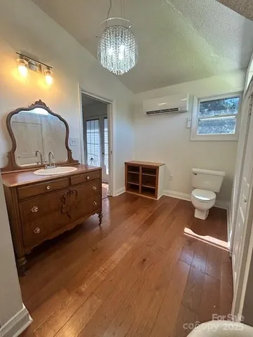 a room with a bed and a chandelier