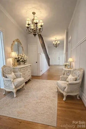 a living room with furniture and a chandelier