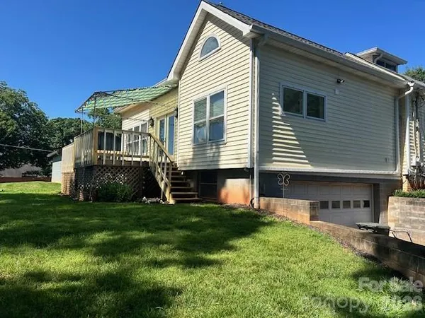 a view of a house with a yard and sitting area