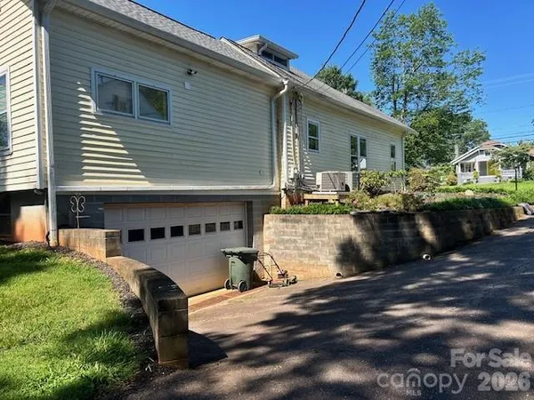a view of backyard of house with outdoor seating