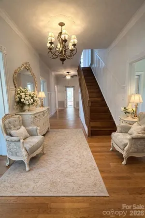 a living room with furniture and a chandelier