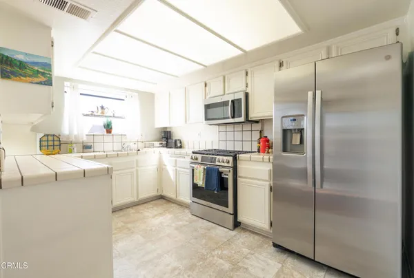 a kitchen with cabinets and stainless steel appliances