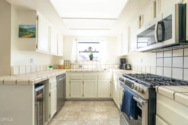 a kitchen with stainless steel appliances granite countertop a stove and a sink