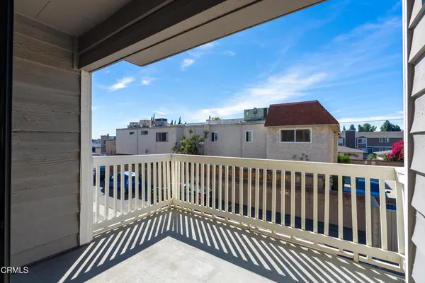 a view of a balcony with wooden fence