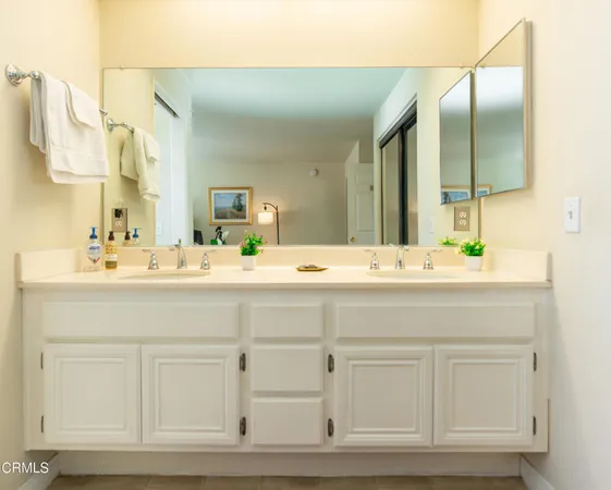 a bathroom with a sink vanity and mirror