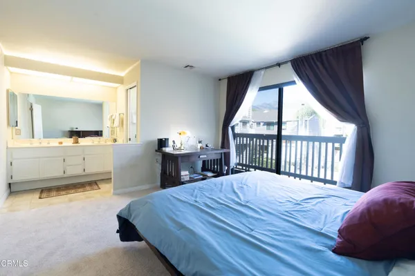 a bed room with a bed and a large window