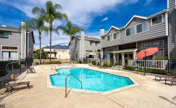 a swimming pool with outdoor seating and yard