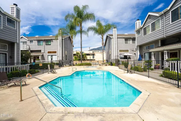 a swimming pool with outdoor seating and yard