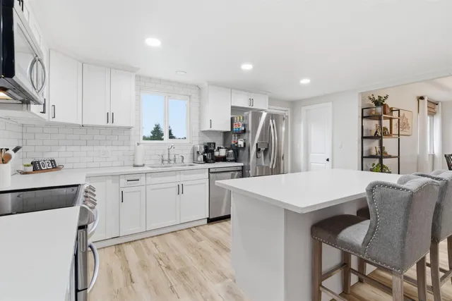 a kitchen with cabinets a sink and appliances