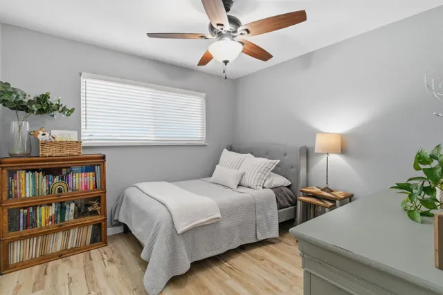 a bedroom with a bed and wooden floor