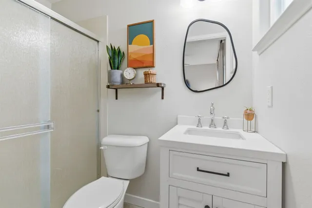 a view of a patio with table and chairs potted plants and a large tree