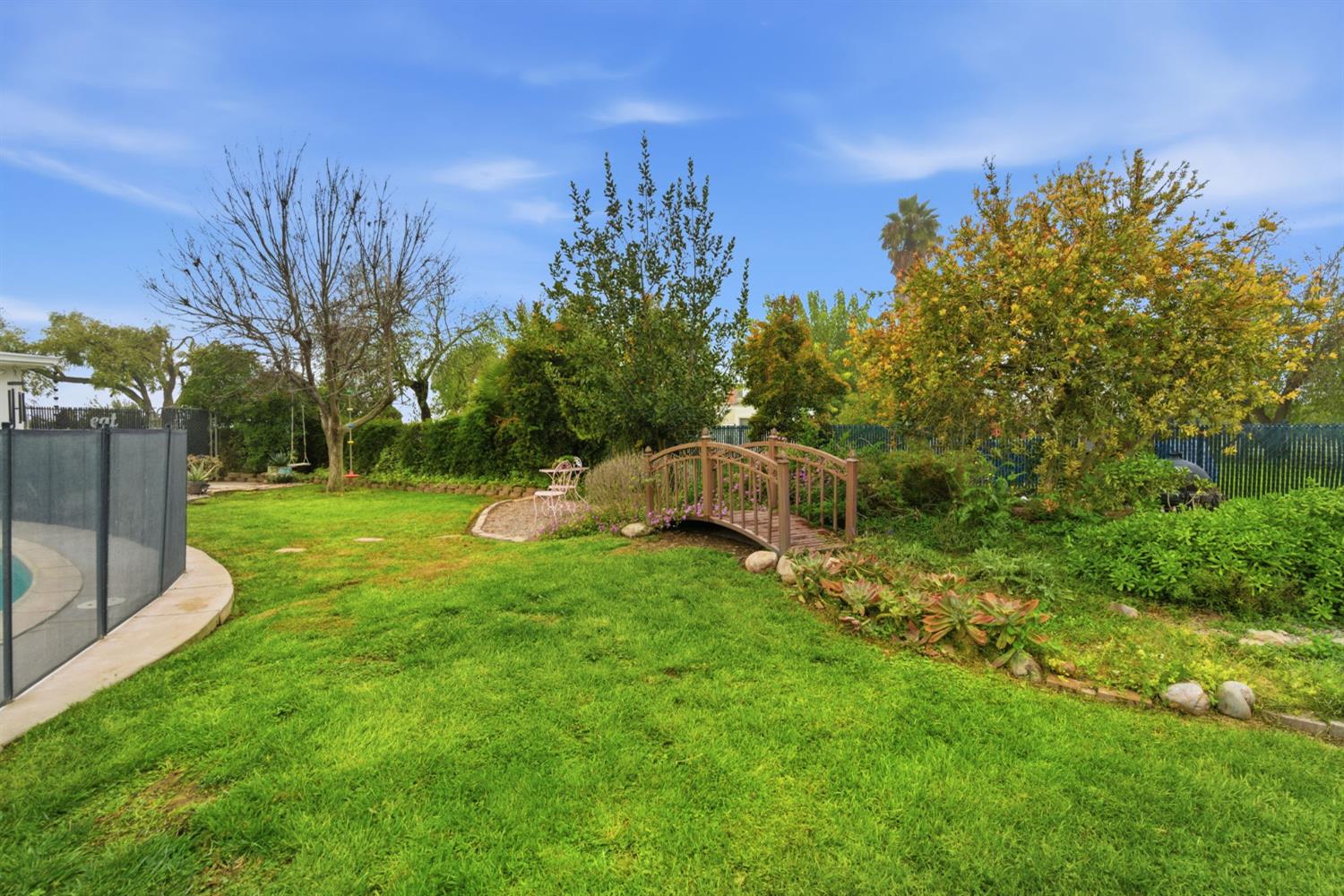 15581 French Camp Road Ripon, CA 95366 - Photo 39 of 54 a backyard of a house with lots of green space and garden