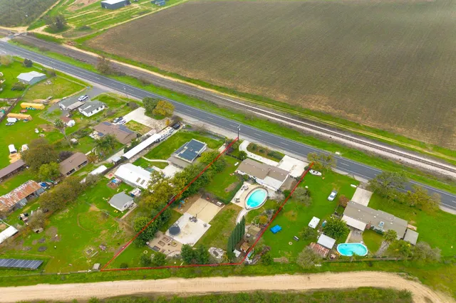 aerial view of a house with pool patio and fire pit