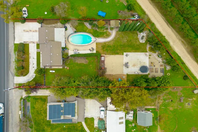 an aerial view of a house with a swimming pool