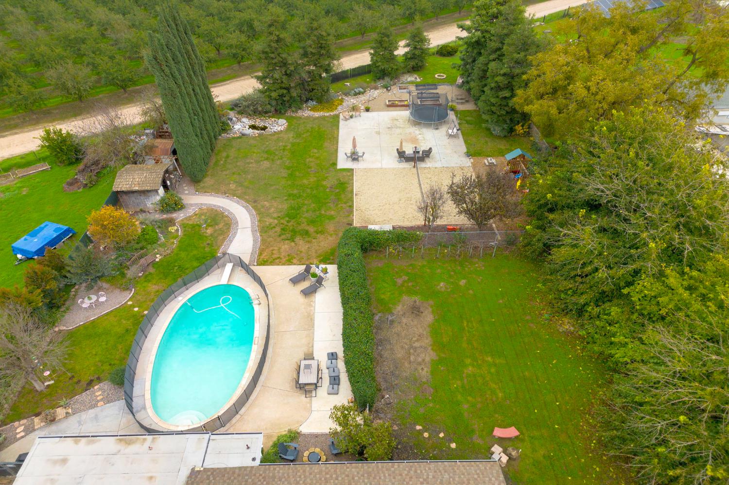 15581 French Camp Road Ripon, CA 95366 - Photo 53 of 54 an aerial view of a house with swimming pool and large trees