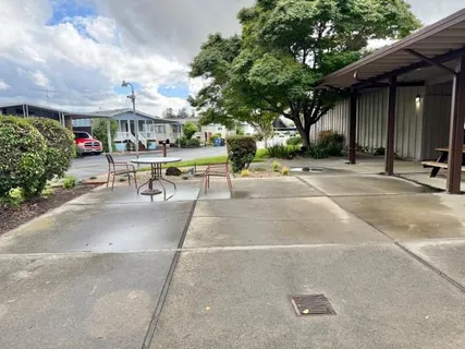 a view of a building with sitting area and garden