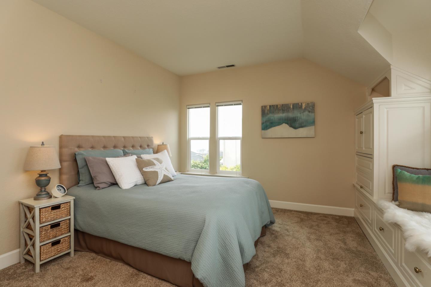 111 Fairview Avenue Capitola, CA 95010 - Photo 12 of 29 a bedroom with a bed and a flat tv screen on dresser