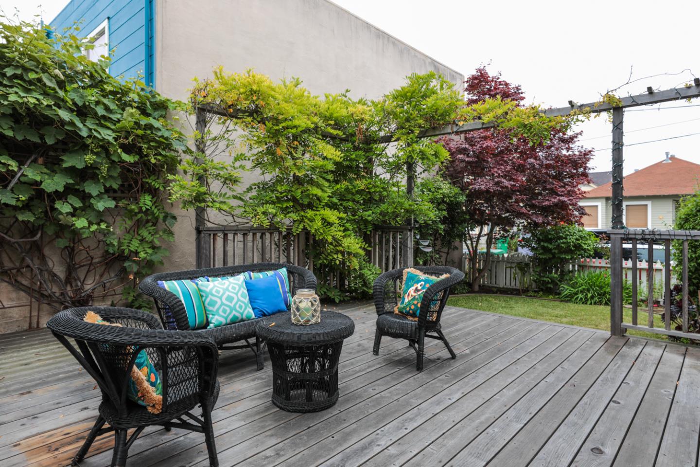111 Fairview Avenue Capitola, CA 95010 - Photo 26 of 29 a view of patio with table and chairs and potted plants with wooden floor