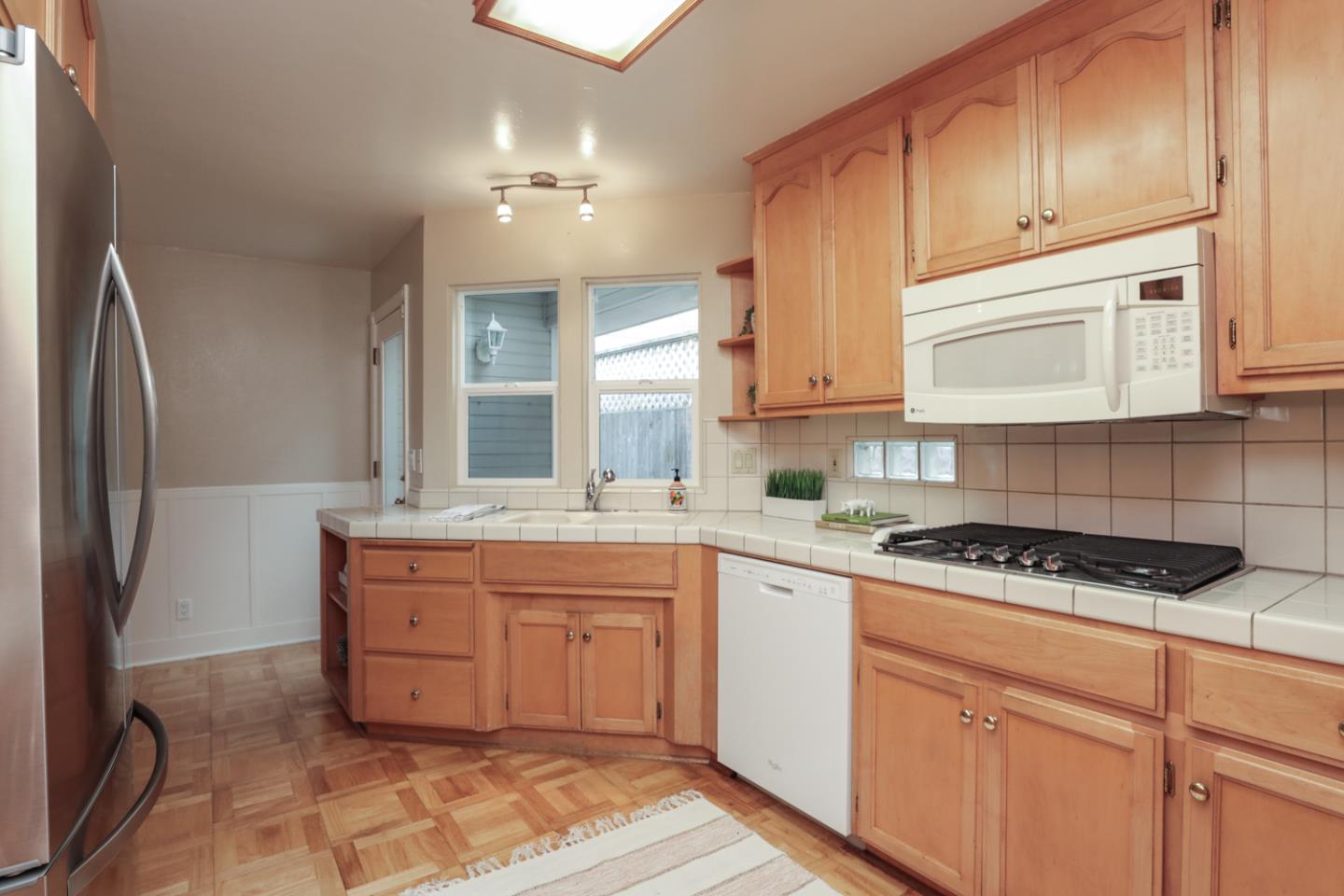 111 Fairview Avenue Capitola, CA 95010 - Photo 8 of 29 a kitchen with stainless steel appliances granite countertop a sink and cabinets