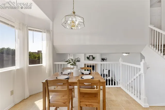 a view of a dining room with furniture and chandelier