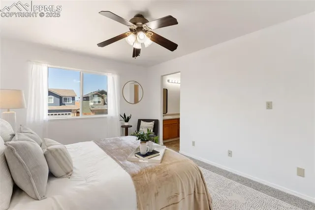 a bedroom with a large bed and a window
