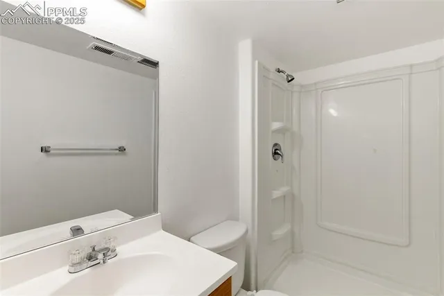 a bathroom with a shower and a sink