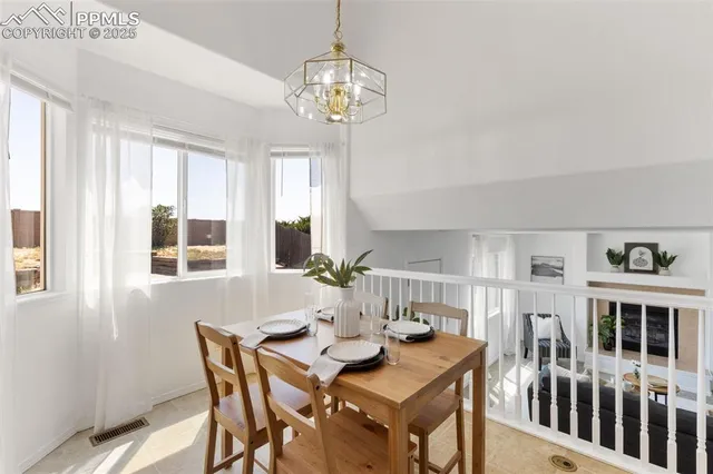 a view of a dining room with furniture window and outside view